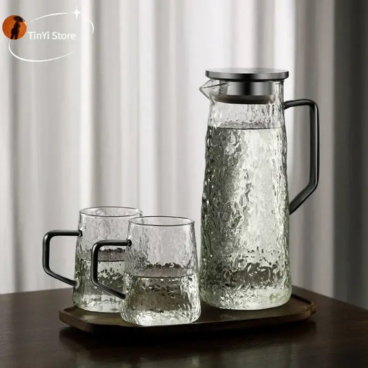 Clear glass water pitcher with hammered textured surface and black metal handle by decorbites gray amber for kitchen use