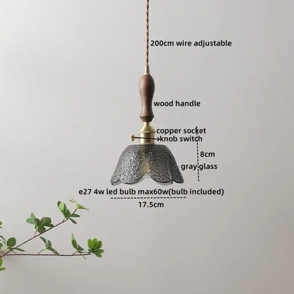 A delicate hammered gray glass led pendant lamp with a textured petal-like design and wooden handle for living room lighting