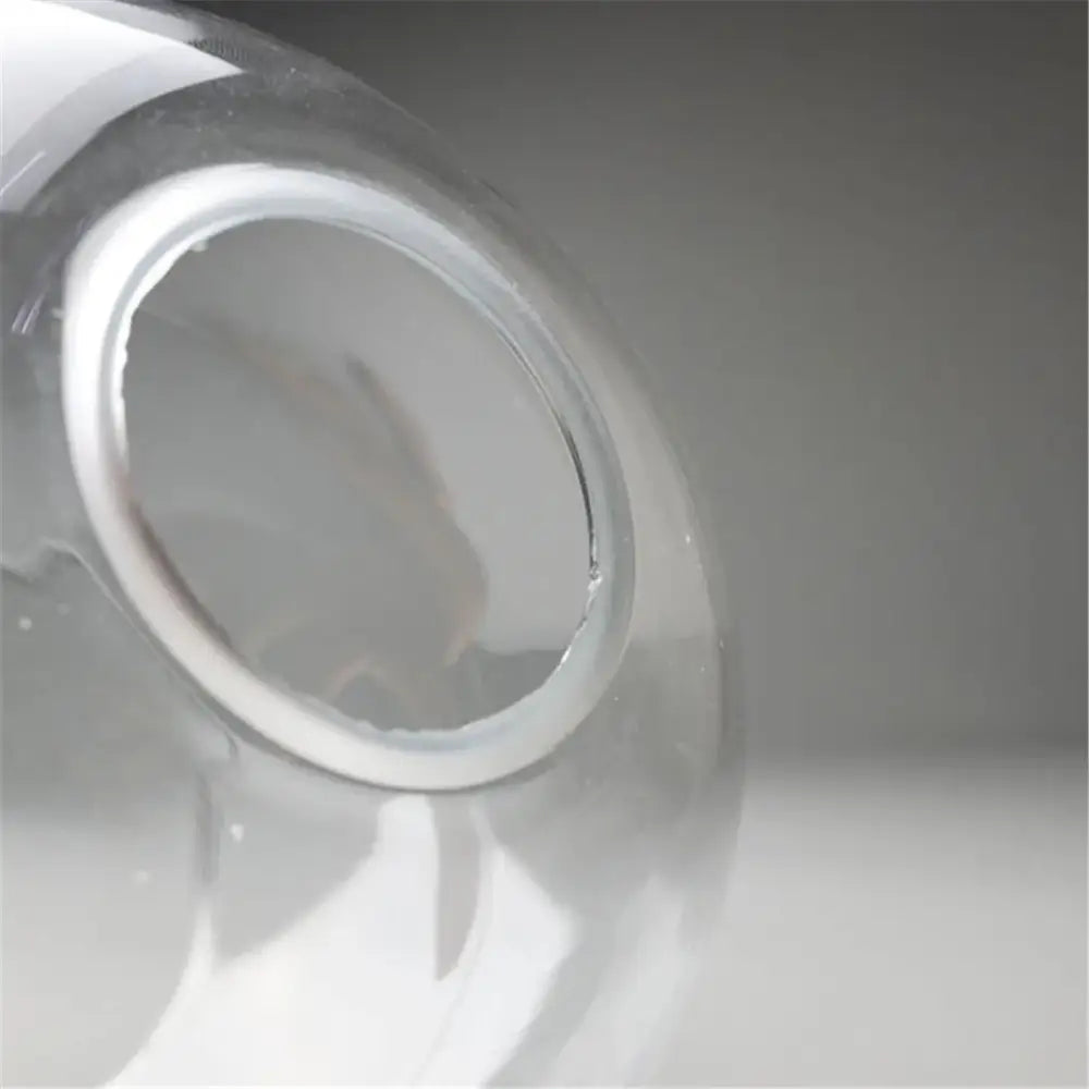 Hand blown clear glass globe lampshade with smooth rounded neck and white plastic seal for living room lighting