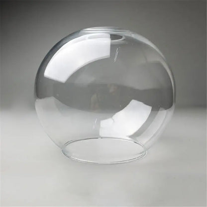 Hand blown clear glass globe lampshade with smooth rounded shape and flat base for living room lighting