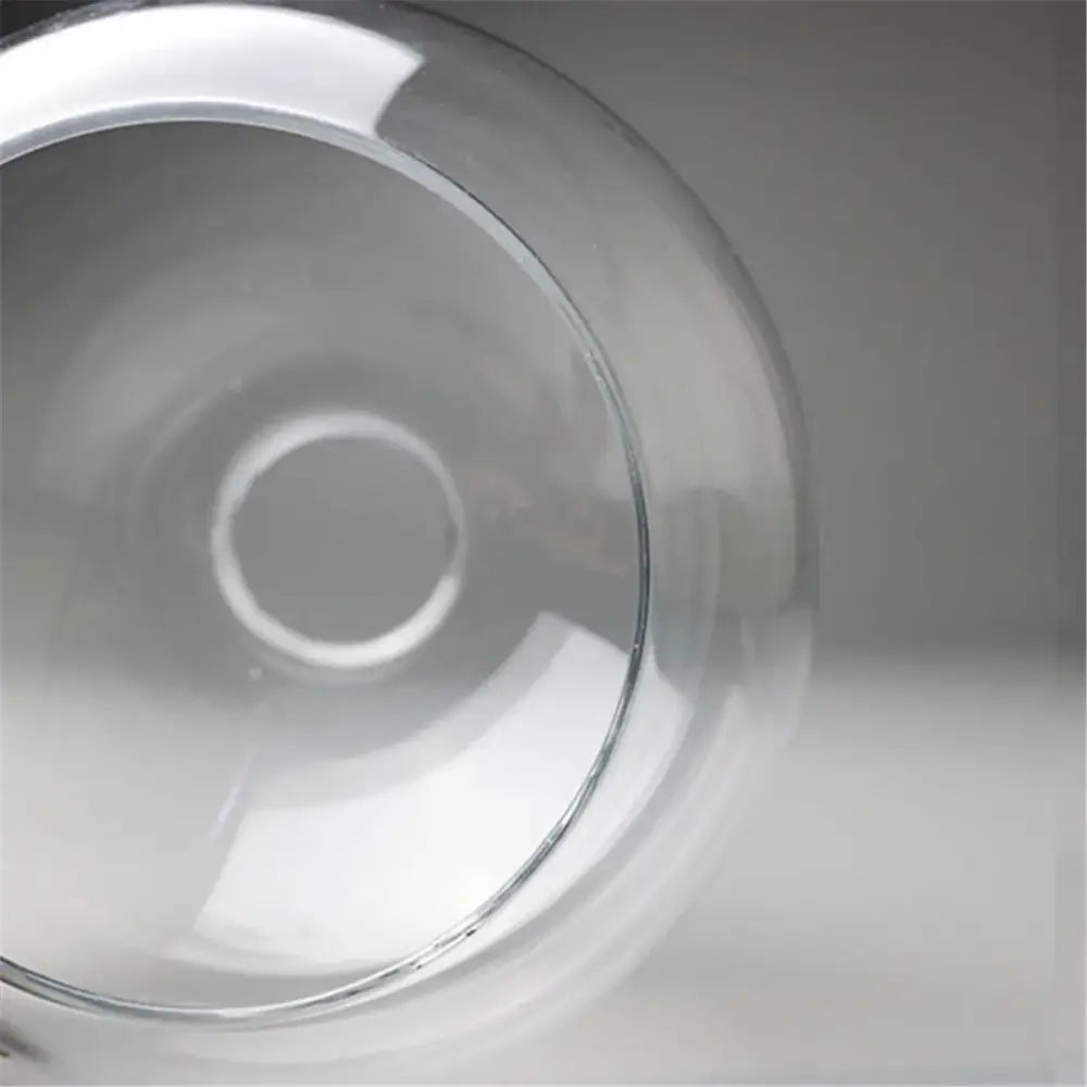 Hand blown clear glass globe lampshade with smooth rounded rim and reflective surface for living room lighting