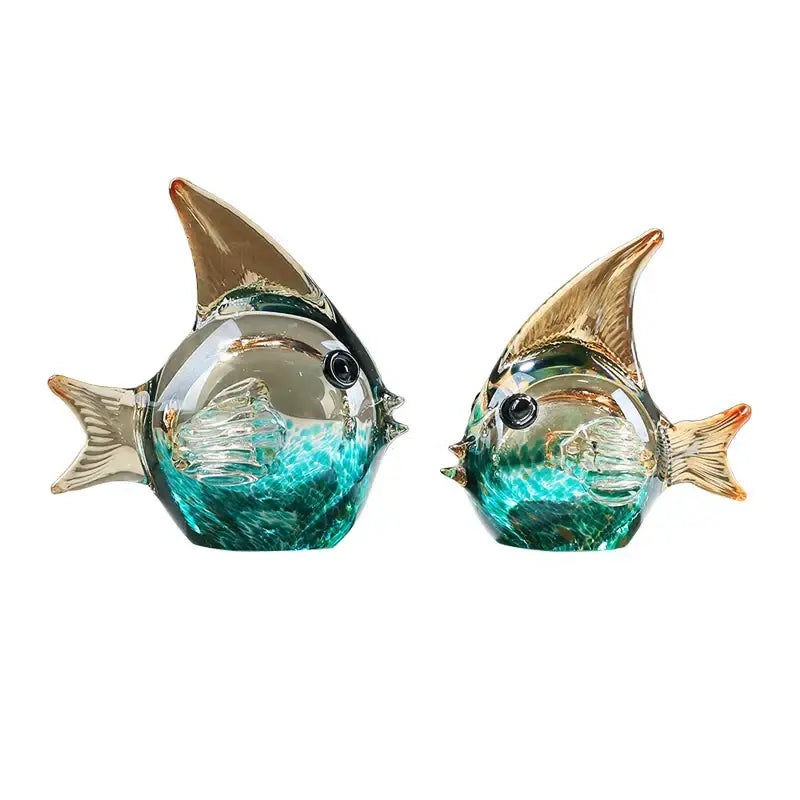 Two translucent teal and gold hand blown glass fish figurines with detailed fins and black bead eyes for decor