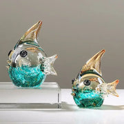 Two hand blown glass fish figurines in turquoise and clear with gold tipped fins for living room decor