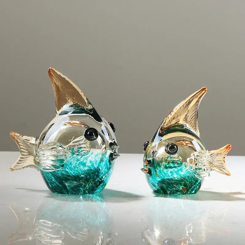 Two hand blown glass fish figurines in turquoise and clear with gold tipped fins and black bead eyes for living room decor