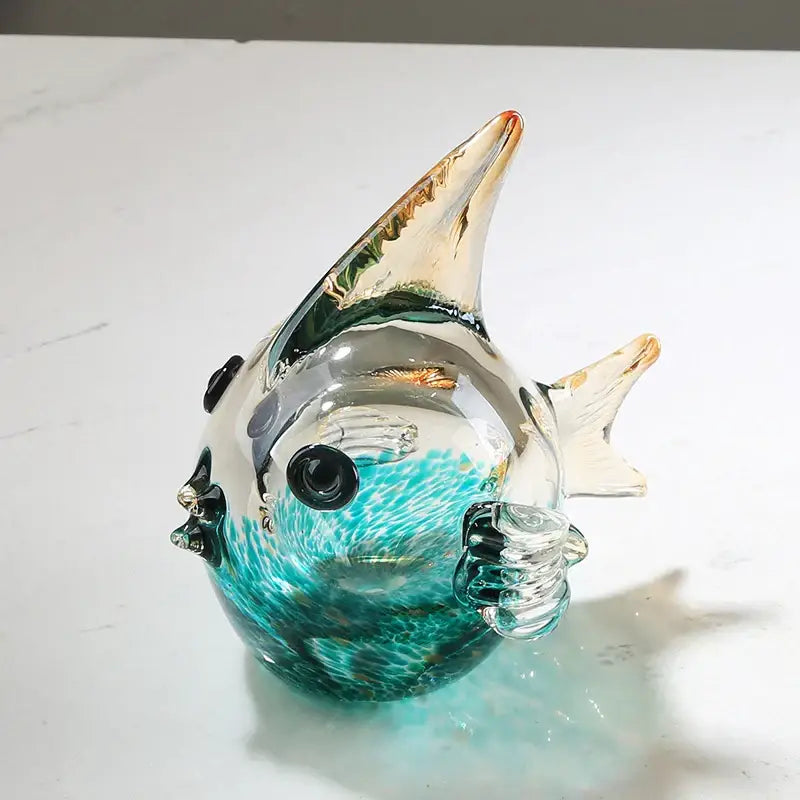 Hand blown glass fish figurine in translucent turquoise with glossy finish and delicate fins for living room decor