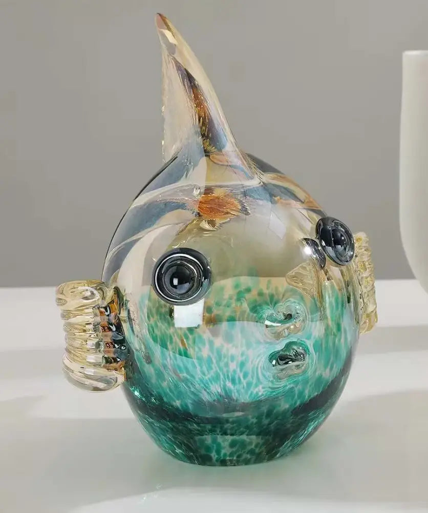 Hand blown glass fish figurine with a teal and gold marbled body and golden fin details for living room decor