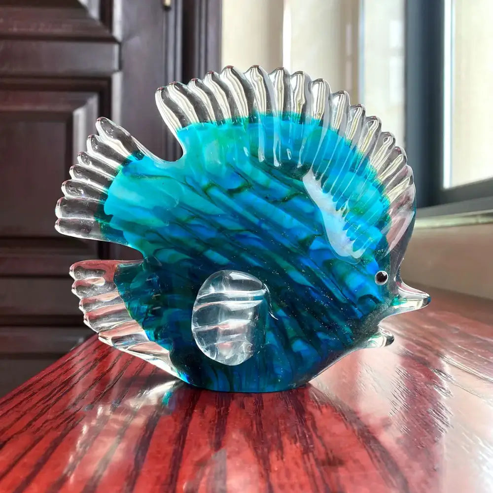 Hand blown tropical glass figurines of a translucent blue and green fish with clear ridged fins for living room decor