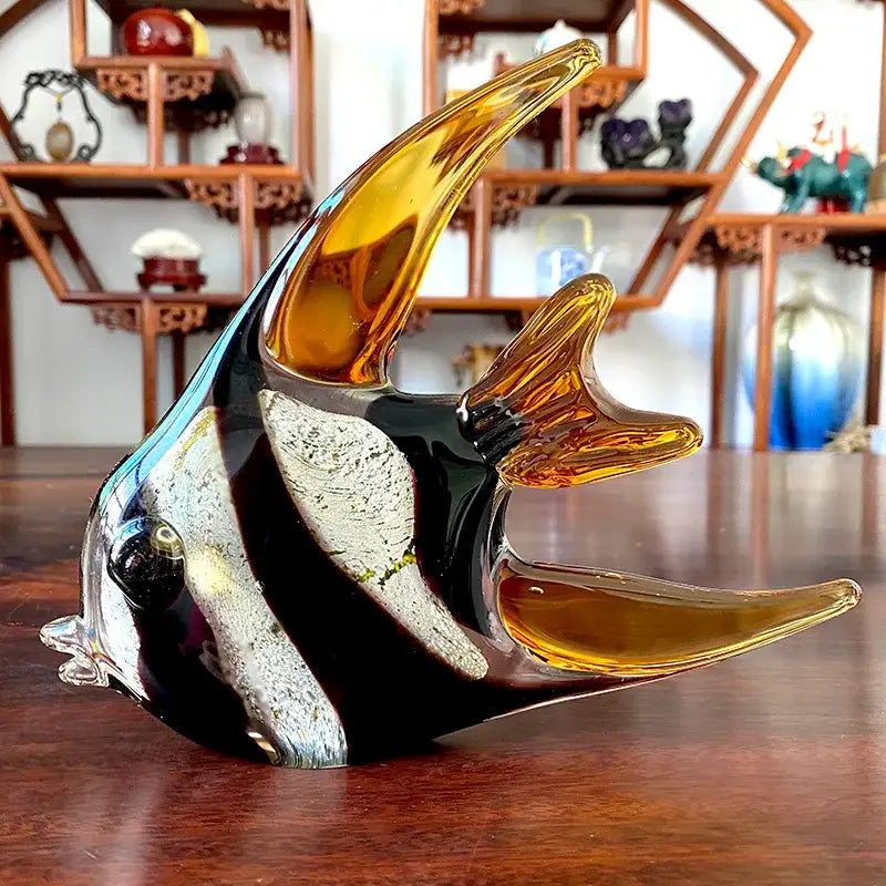 Hand blown tropical glass figurines featuring a glossy black fish with silver and amber fins for living room decor