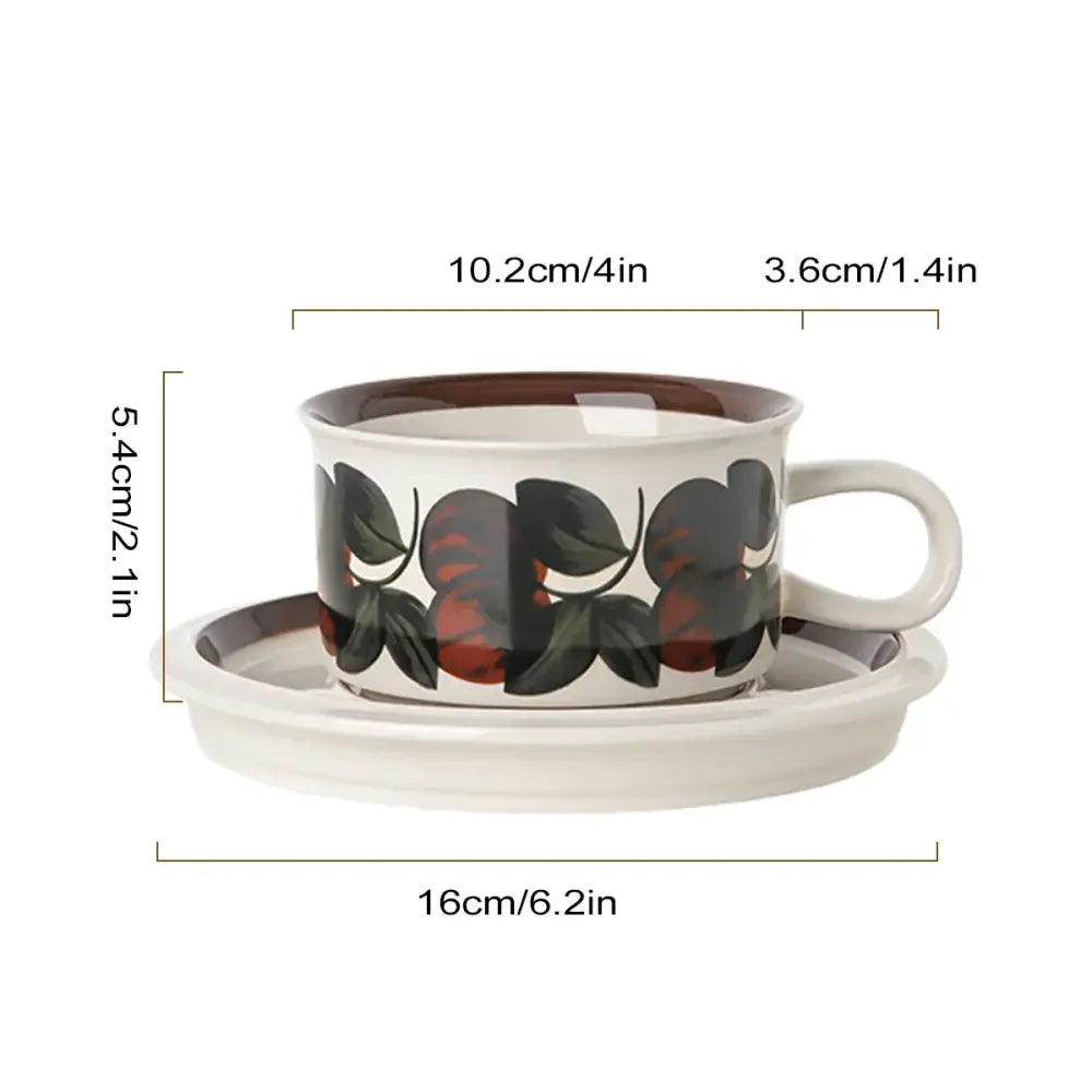 White ceramic espresso cup with brown rim and black and red fruit pattern paired with matching saucer dining set