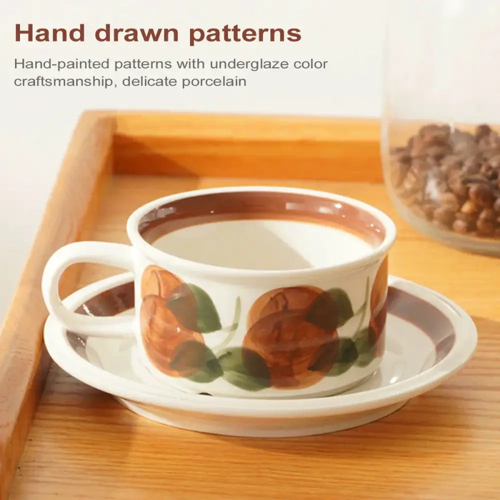 White ceramic espresso cup with hand-painted orange and green fruit patterns and a brown rim dining room set