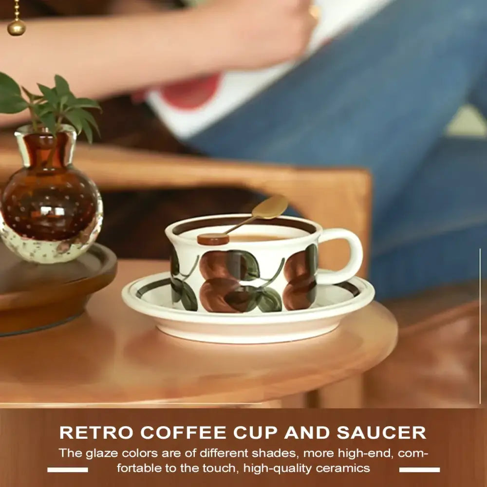 White ceramic espresso cup and saucer set with hand-drawn brown and green leaf fruit-patterned glaze