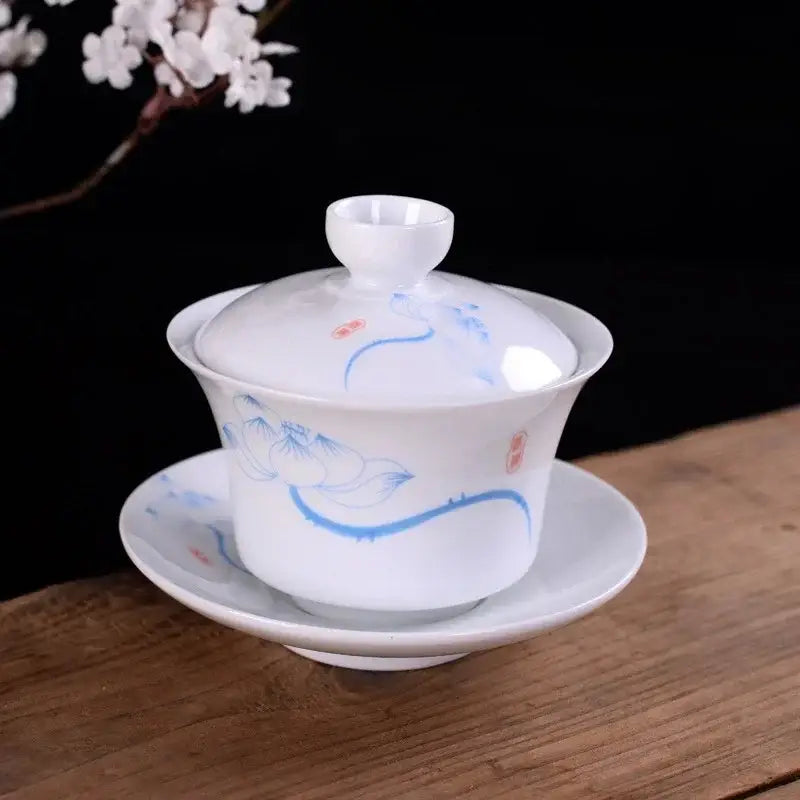 White porcelain gaiwan teacup with hand-painted blue lotus vines and red seals for decorbites blue tea set