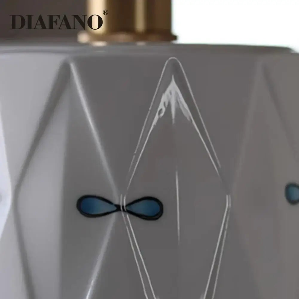 A sleek white faceted perfume bottle with gold cap and blue infinity symbol featured with decorbites ceramic pendant light