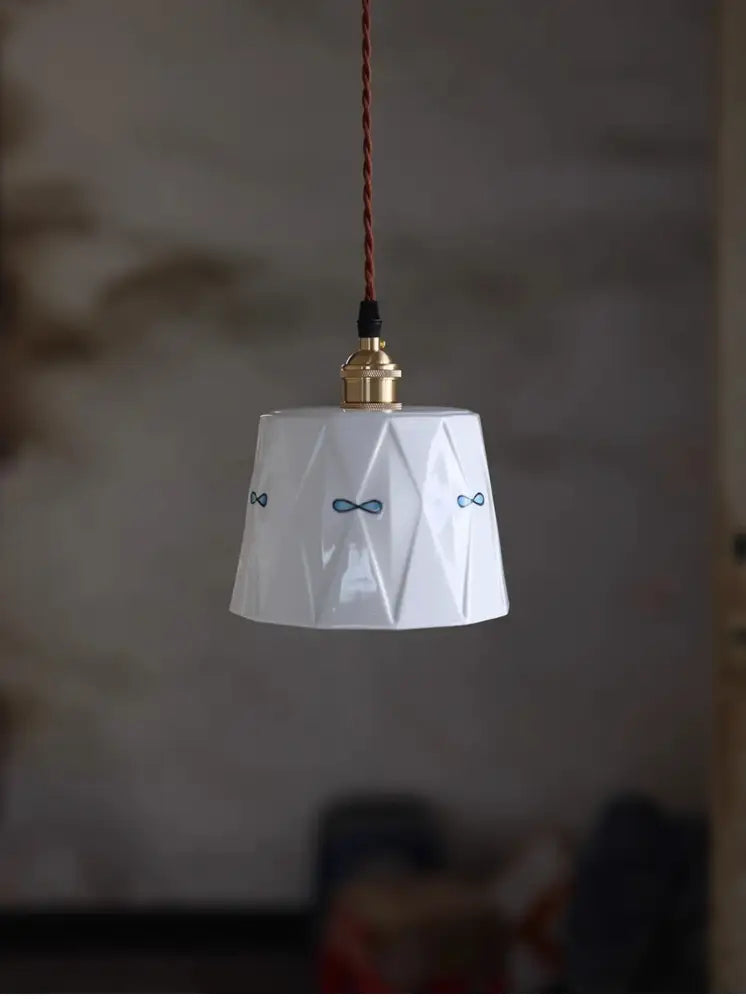Hand painted cream decorbites ceramic pendant light with geometric facets and blue bow decals for dining room use