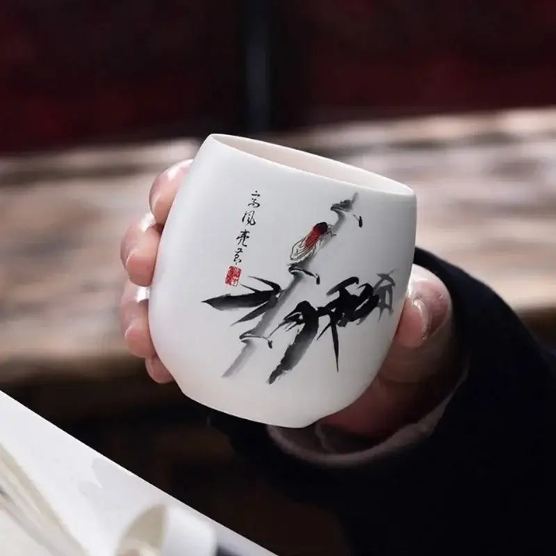 Hand-painted floral white porcelain kung fu tea cup featuring a delicate bird ink painting for decorbites ceramic kung use