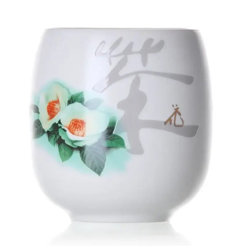 A white porcelain kung fu tea cup with hand-painted green and orange floral design by decorbites ceramic kung