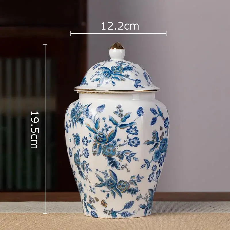 White porcelain tea canister with hand-painted blue floral patterns and a gold-trimmed lid for kitchen storage