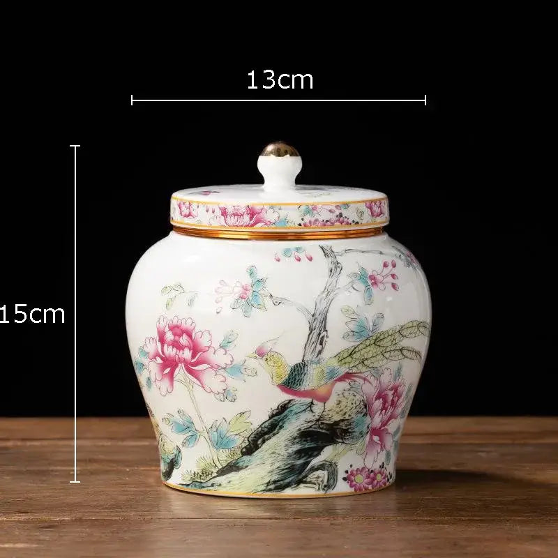 Hand-painted floral white porcelain tea canister with gold-trimmed lid featuring pink peonies and colorful birds design