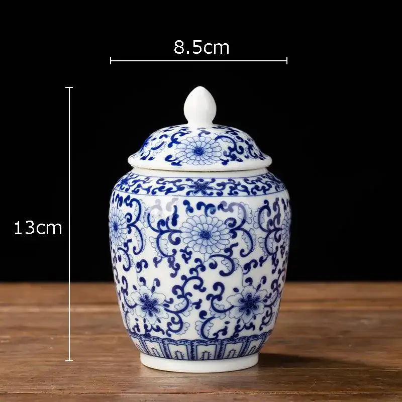 Hand-painted white porcelain tea canister with intricate blue floral patterns and a matching lid for kitchen storage