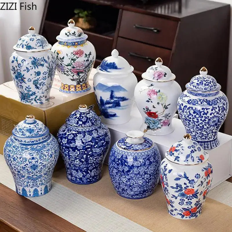 Hand-painted white porcelain tea canister with blue floral and landscape designs and gold accents on lids for kitchen storage