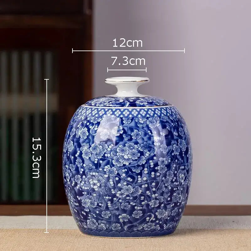 Glossy blue and white porcelain tea canister with intricate floral patterns and matching lid for kitchen storage
