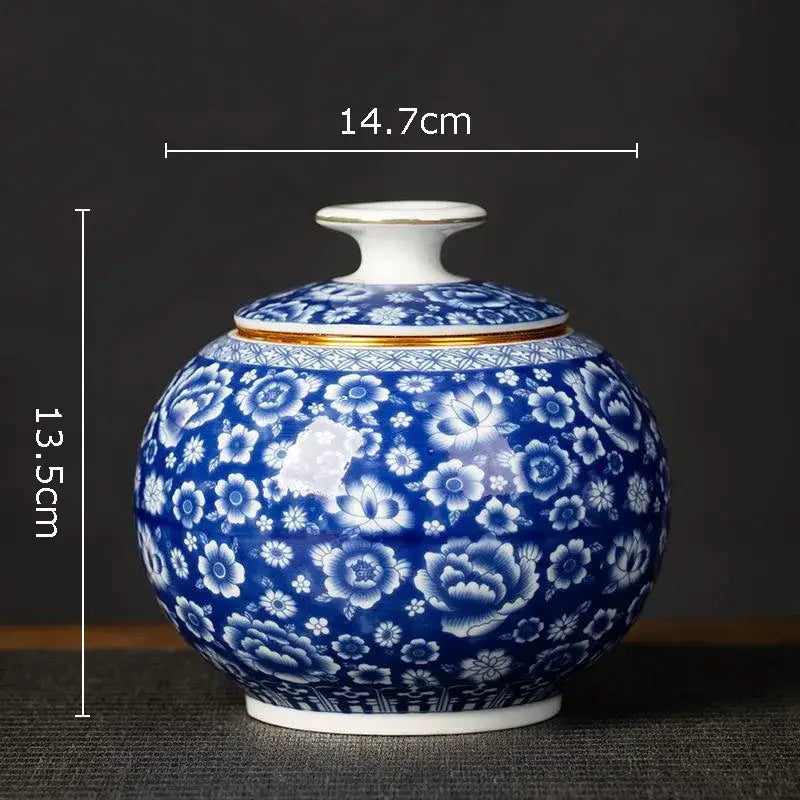 Hand-painted round blue and white porcelain tea canister with floral pattern and gold trim for kitchen storage