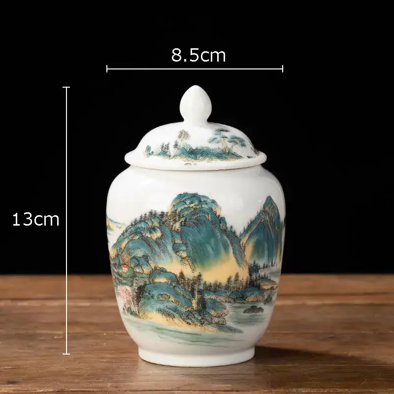 White porcelain tea canister with lid featuring hand-painted traditional chinese landscape in green blue and gold