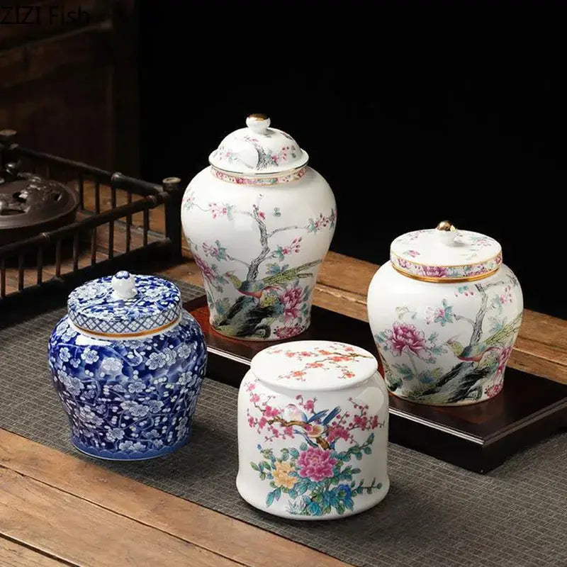 White porcelain tea canister with intricate hand-painted floral and bird motifs in vibrant pinks blues and greens