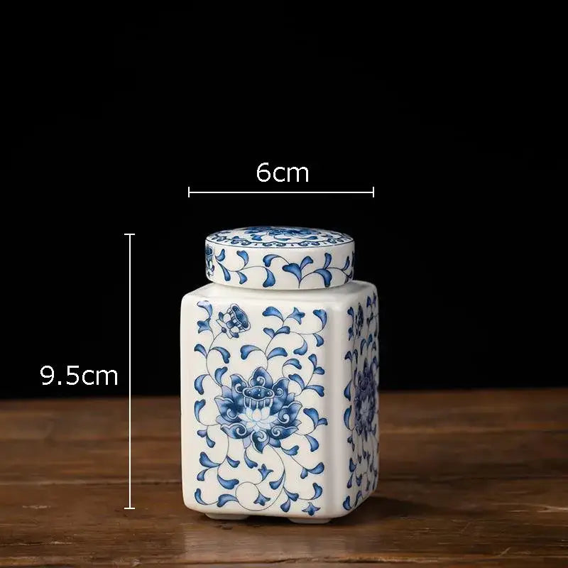 Hand-painted white porcelain tea canister with blue floral patterns and matching lid for kitchen storage