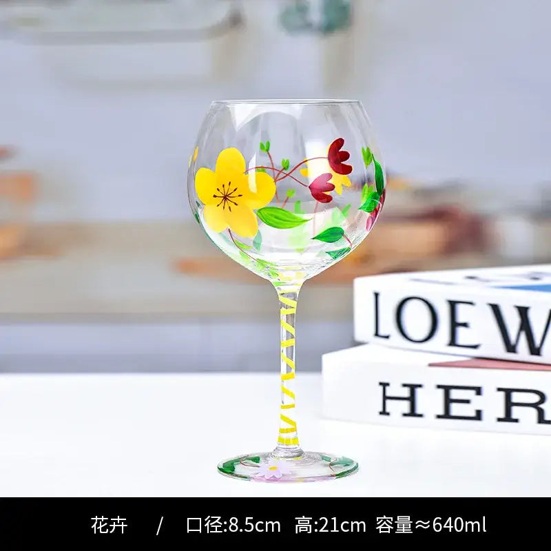 Hand-painted floral wine goblet featuring vibrant yellow red and green flowers with a striped stem by decorbites crystal