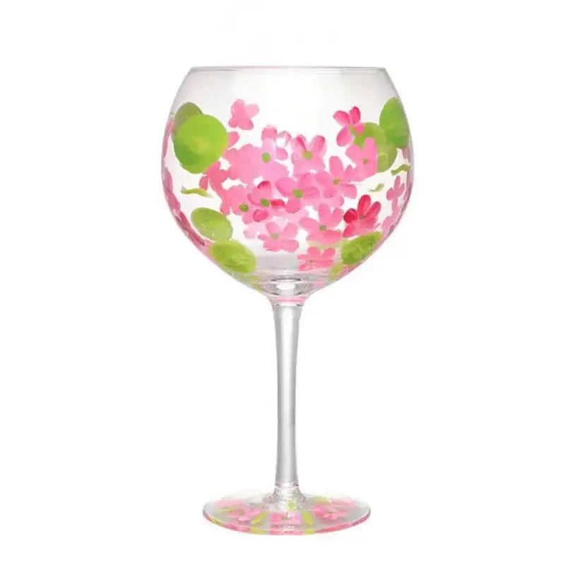 A clear glass floral wine goblet with hand-painted pink flowers and green leaves by decorbites crystal for dining room use
