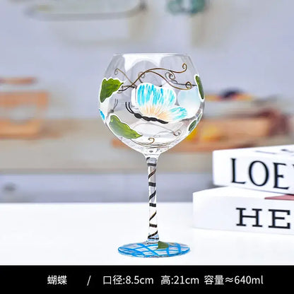 Hand-painted floral wine goblet with blue butterfly and green leaves on decorbites crystal for elegant dining