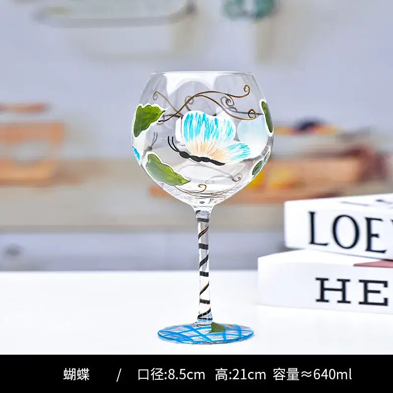 Hand-painted floral wine goblet with blue butterfly and green leaves on decorbites crystal for elegant dining