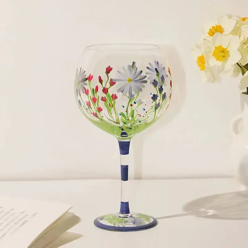 Hand-painted floral wine goblet with red white purple flowers green stems and navy blue bands by decorbites crystal