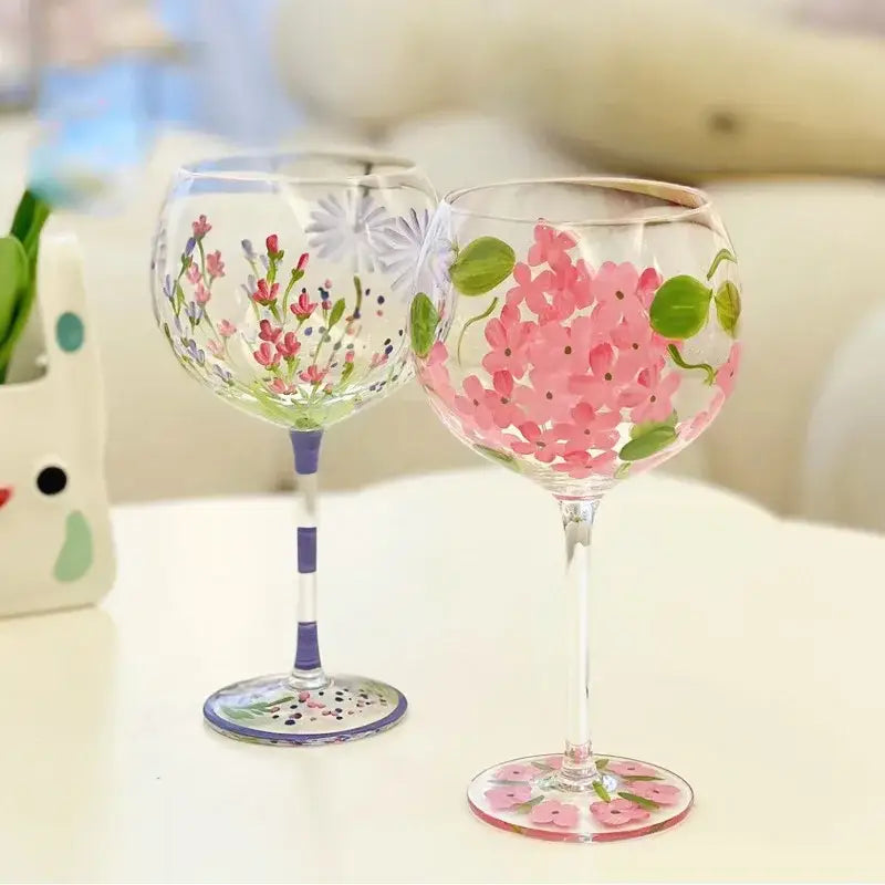 Hand-painted floral wine goblet with pink purple green floral designs on clear decorbites crystal glass stemware