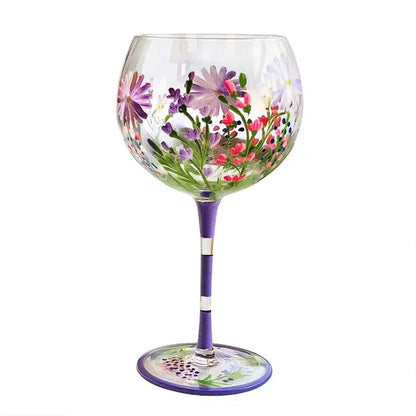 Hand-painted floral wine goblet with vibrant purple pink and green design on clear crystal glass by decorbites