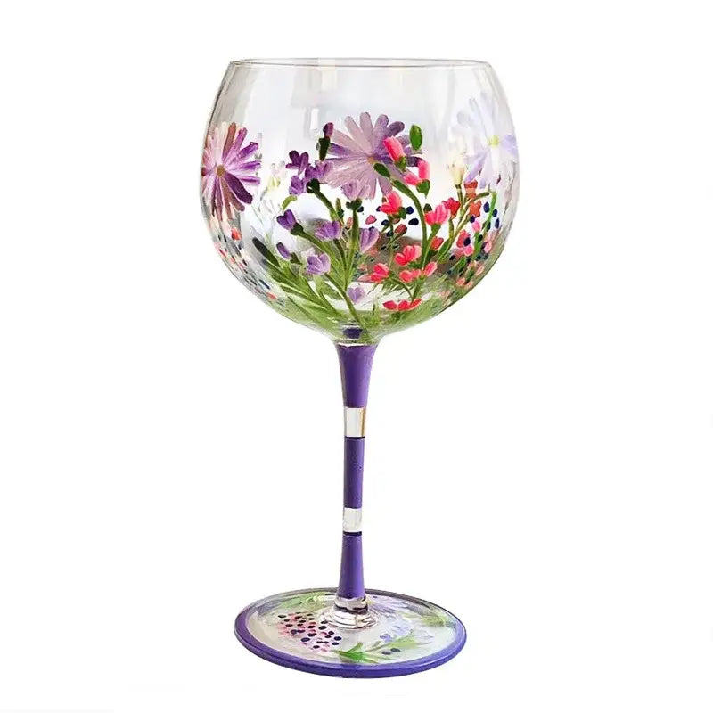 Hand-painted floral wine goblet with vibrant purple pink and green design on clear crystal glass by decorbites