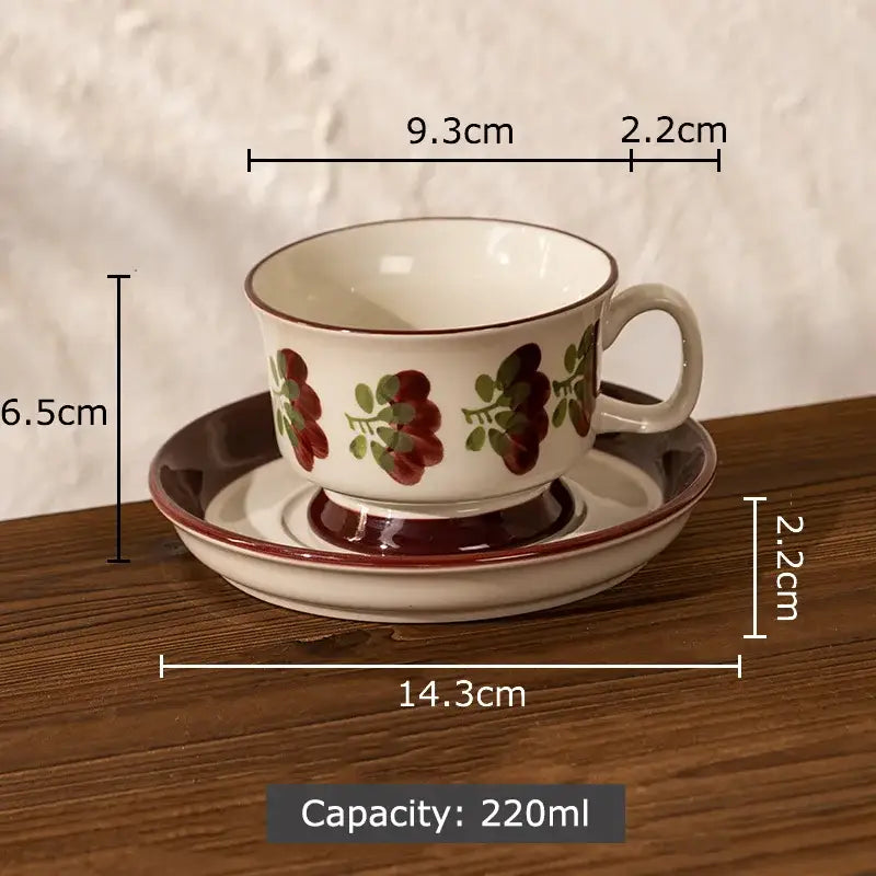 A hand-painted decorbites flowers pattern ceramic cup and saucer set in white with red and green floral design for dining room use