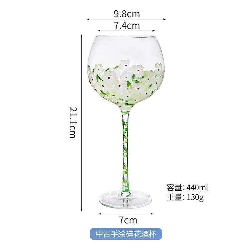 Hand painted glass goblet with white floral design pink and yellow accents 21.1cm tall 440ml capacity for dining decor