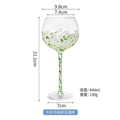 Hand painted glass goblet with white and green floral design pink and yellow decor 21.1cm height 440ml capacity