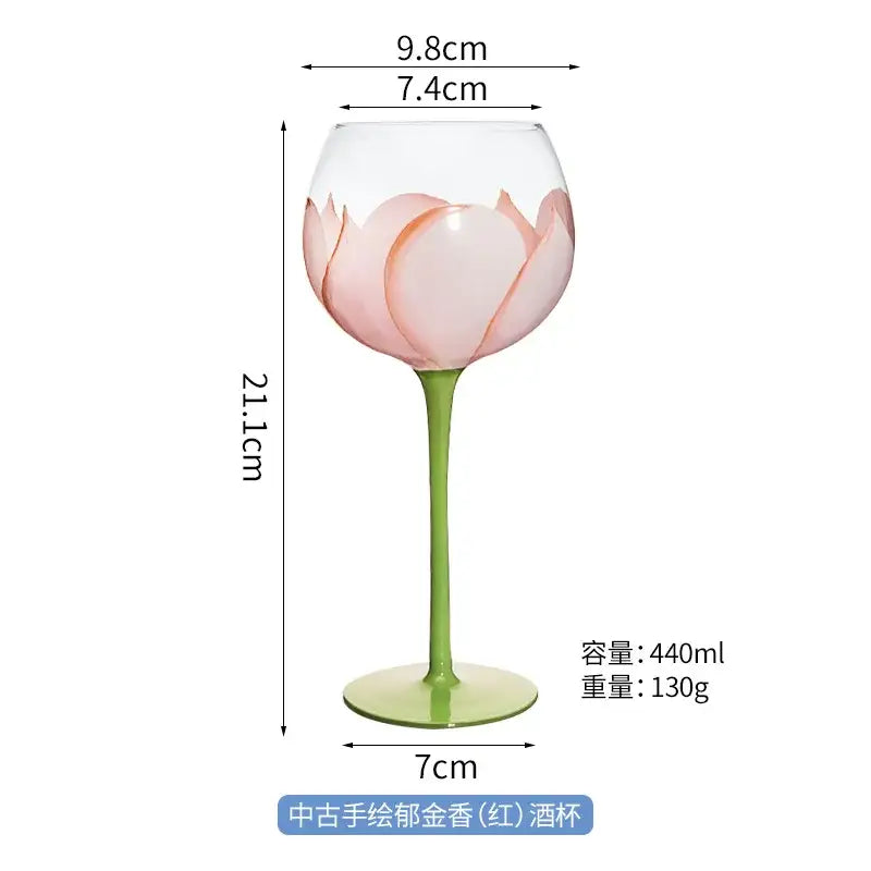 Hand painted glass goblet with delicate pink lotus floral design and slender green stem for dining room decor