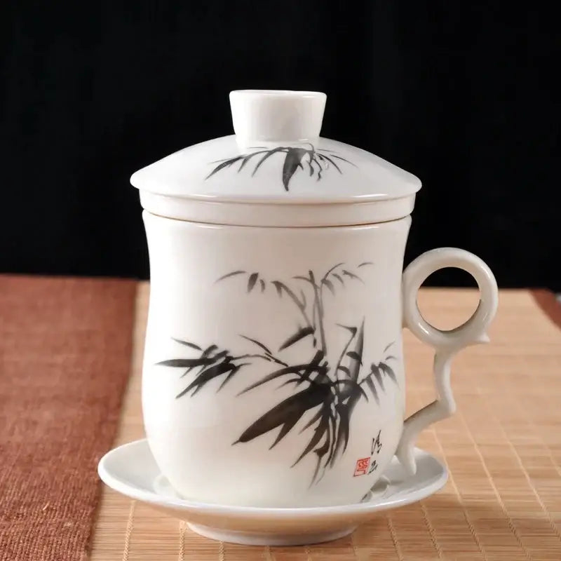Hand painted lotus white porcelain tea cup with filter featuring black bamboo brushwork on matching lid and saucer