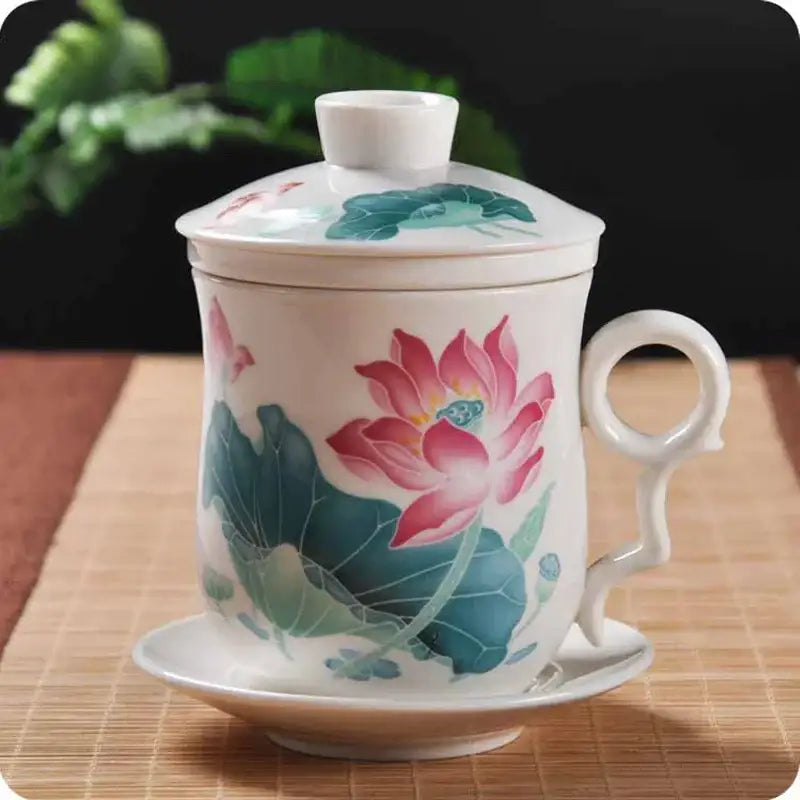 A white porcelain tea cup with hand painted pink lotus flowers and green leaves with matching lid and saucer