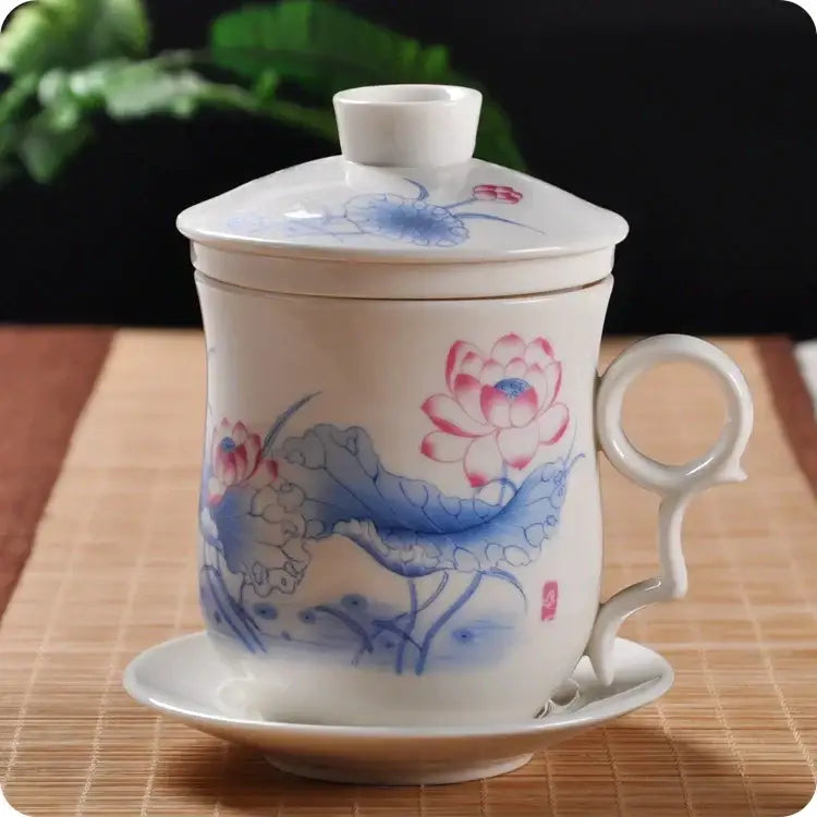 Hand painted lotus white porcelain tea cup with filter featuring pink and blue lotus design on lid and saucer