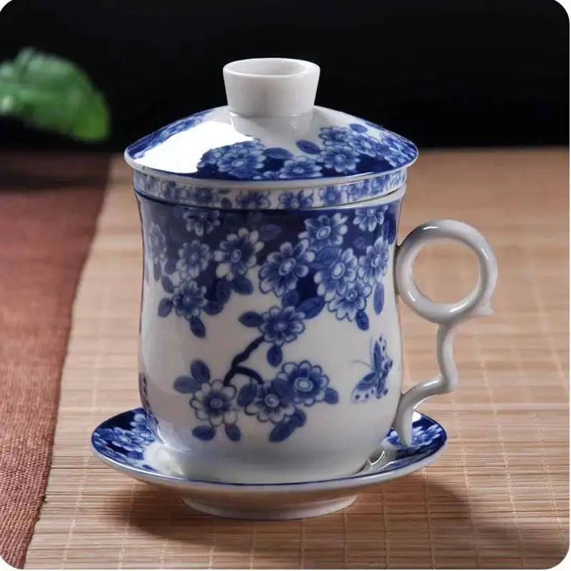 Hand painted lotus white porcelain tea cup with filter featuring blue floral pattern and elegant curved handle for dining room