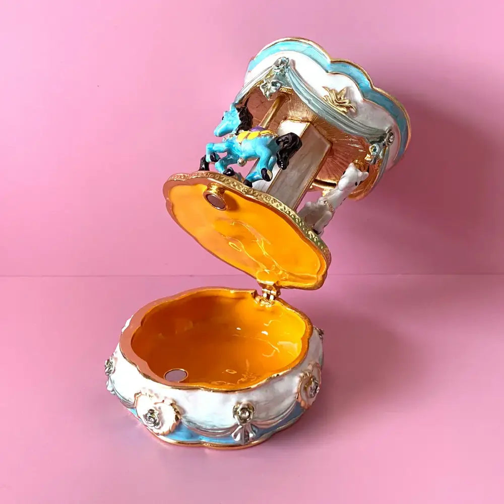 Hand painted porcelain carousel horse trinket box with blue and white horses and gold accents for bedroom decor