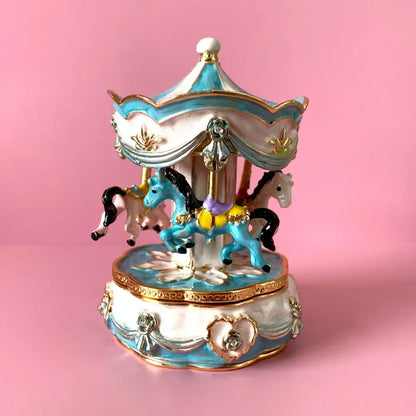 Hand painted pastel blue and white porcelain carousel horse trinket box with gold accents and miniature horses in motion