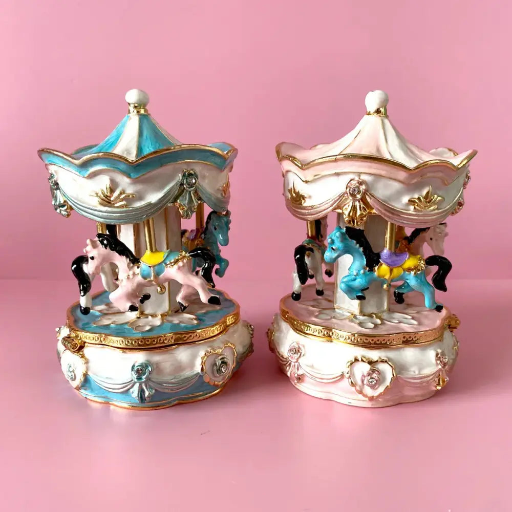 Two hand painted pastel porcelain carousel horse trinket boxes in blue white and pink gold for bedroom decor
