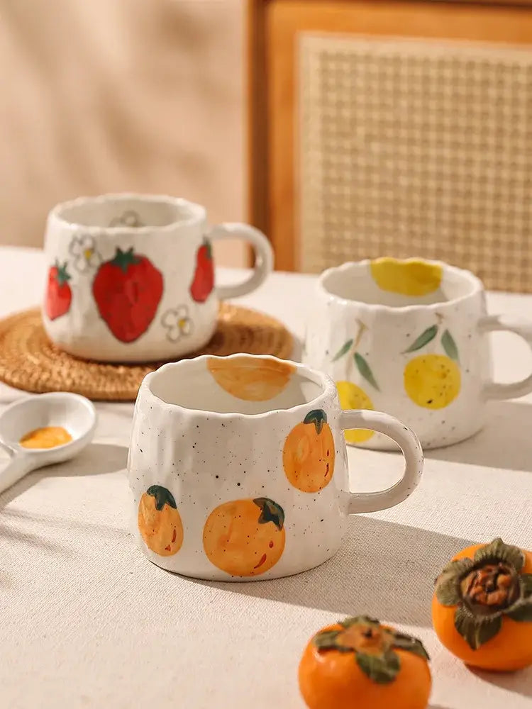 White ceramic cartoon fruit ceramic mugs with speckled texture and hand-painted red yellow orange fruit decorbites cartoon fruit