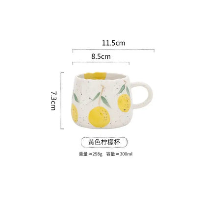 Hand-painted cartoon fruit ceramic mug with speckled white texture featuring yellow lemons and green leaves for kitchen use